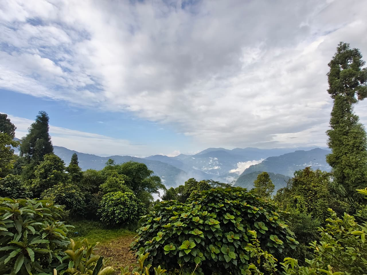 Clouds over the peaceful green hills surrounding Ralong